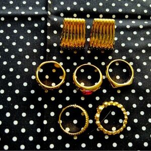 Set of 5 stylish rings and gold tone clip on earrings.